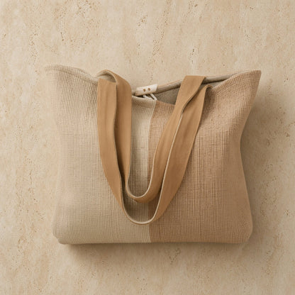 Beige handwoven ethiopian cotton tote bag with tan fabric straps and button closure perfect for everyday use