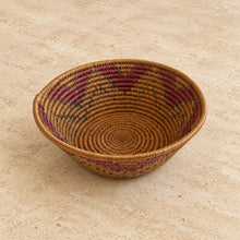 Handwoven large african zulu bowl with subtle star pattern in maroon and green on a natural tan base sustainably sourced in south africa