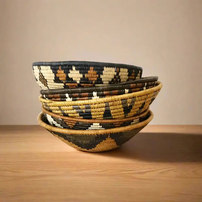 Stacked woven handwoven large african zulu bowls with geometric patterns in beige black and brown made from sustainably sourced ilala palm south africa