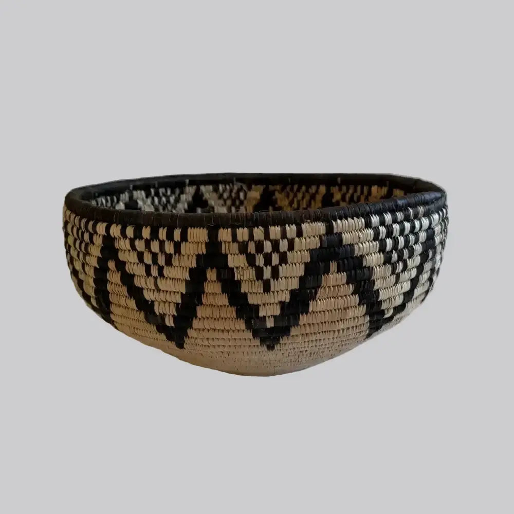 Handwoven large african zulu bowl with black and beige geometric patterns made from sustainably sourced ilala palm in south africa