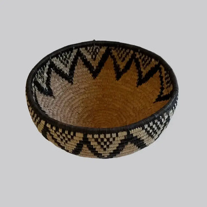 Handwoven large african zulu bowl with bold black and beige zigzag patterns made from sustainably sourced ilala palm south africa