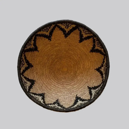 Handwoven large african zulu bowl with sunburst pattern in tan and black made from sustainably sourced ilala palm from south africa