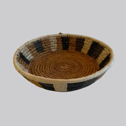 Handwoven medium african zulu bowl with black and cream stripes on natural tan ilala palm from south africa sustainably sourced