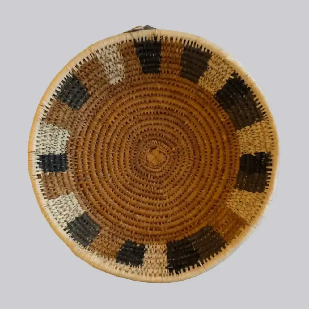 Handwoven medium african zulu bowl with tan base and black beige geometric patterns made from sustainably sourced ilala palm in south africa