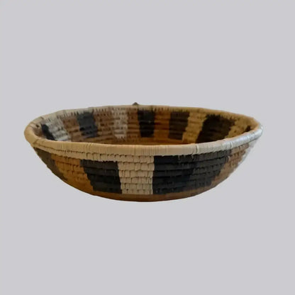 Handwoven medium african zulu bowl with black beige tan stripes made from sustainably sourced ilala palm fibers from south africa