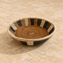 Handwoven medium african zulu bowl with geometric black beige natural brown stripes made from sustainably sourced ilala wild grasses