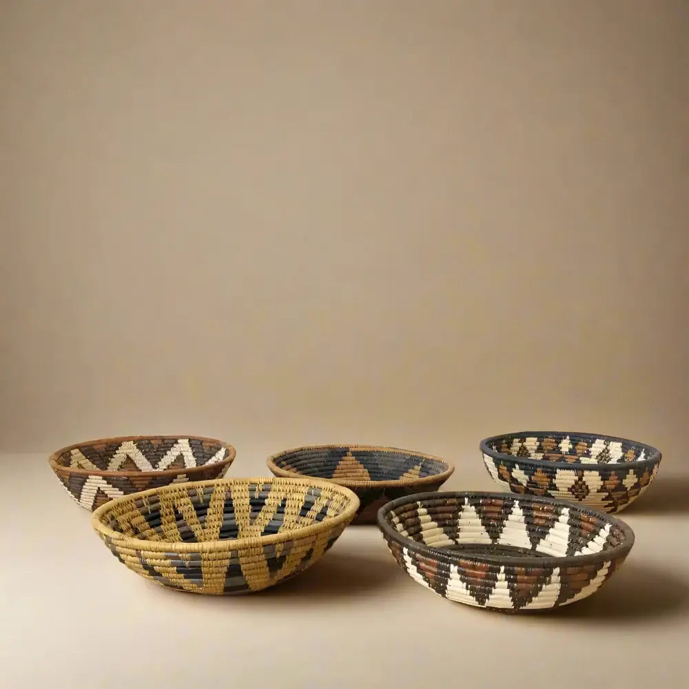 Handwoven medium african zulu bowl in natural black and beige ilala palm with geometric pattern sustainably sourced from south africa