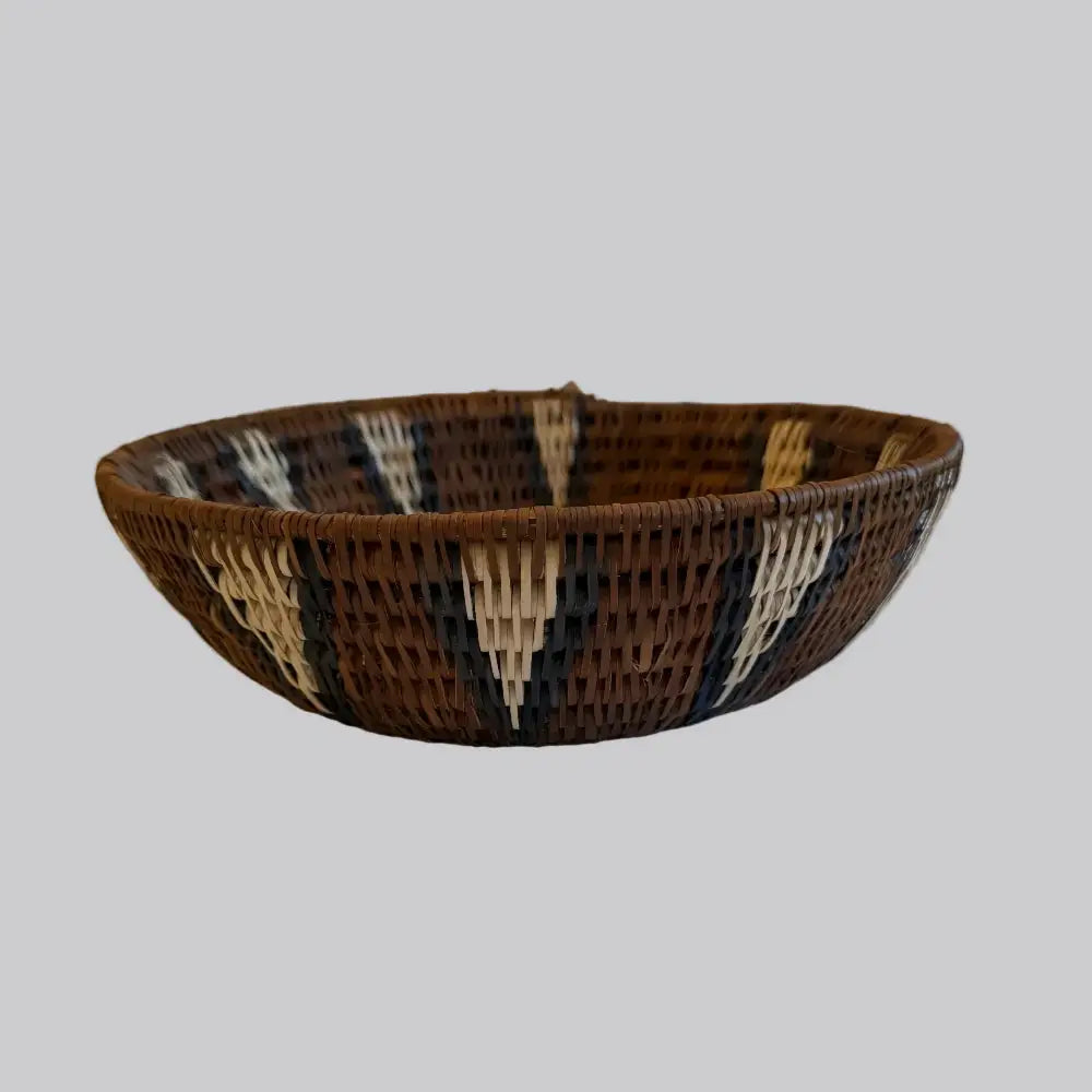 Handwoven medium african zulu bowl made from sustainably sourced ilala palm with brown black and cream geometric design from south africa