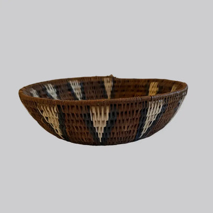 Handwoven medium african zulu bowl made from sustainably sourced ilala palm with brown black and cream geometric design from south africa