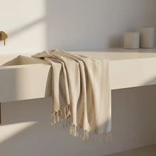 Cream-colored fringed Turkish hand towel in natural light brown stripes