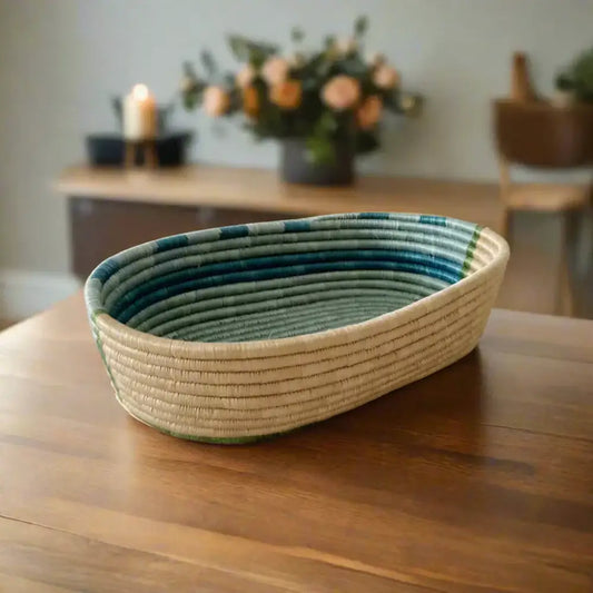 Handwoven sisal bread basket with blue stripes, perfect for serving and organizing essentials