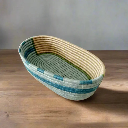 Handwoven sisal bread basket with blue, green, and tan stripes for serving organizing essentials