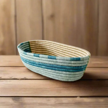 Handwoven sisal bread basket with teal and light blue stripes for serving organizing essentials