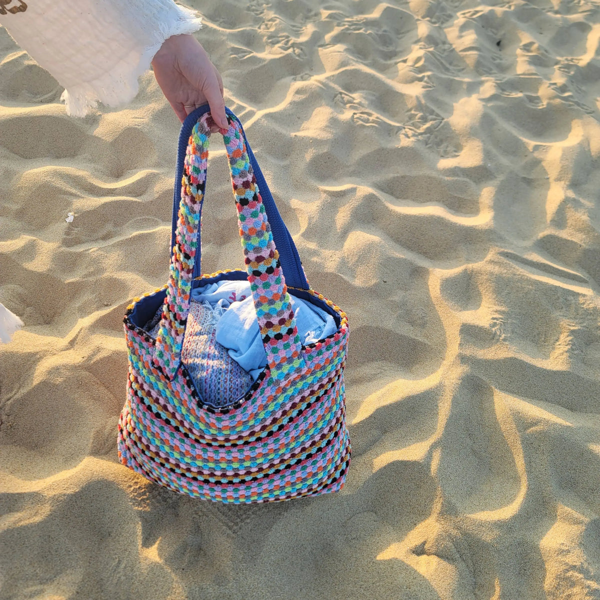 Colorful handwoven tote bag with blue lining, perfect as a large multicolor tote or pom pom tote
