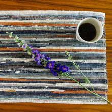 Handwoven upcycled fabric placemat with colorful stripes and woven texture