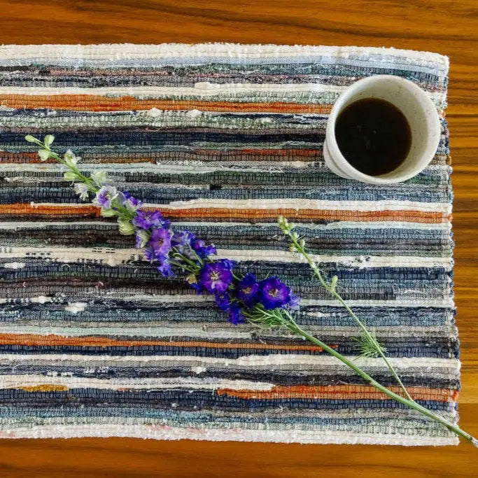 Handwoven upcycled fabric placemat with colorful stripes and woven texture