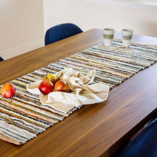 Handwoven Upcycled Fabric Table Runner on a wooden table with fruit and coffee cups