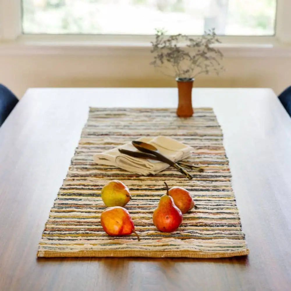 Handwoven Upcycled Fabric Table Runner on a table with fruit and flowers