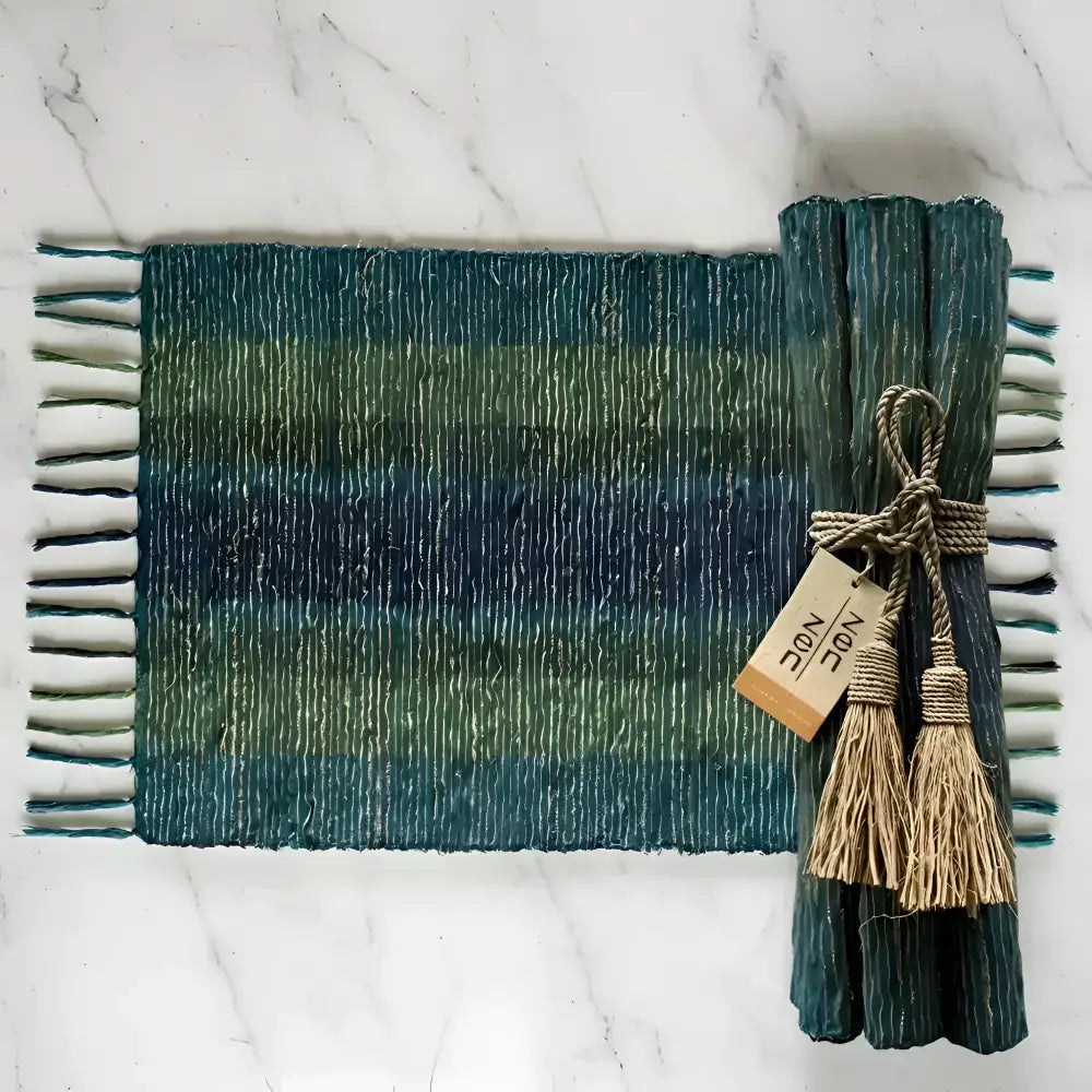 Handwoven vetiver placemats set of 6 in teal green stripes with fringed edges tied with natural twine and tassels