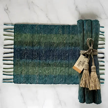 Handwoven vetiver placemats set of 6 in teal green stripes with fringed edges tied with natural twine and tassels
