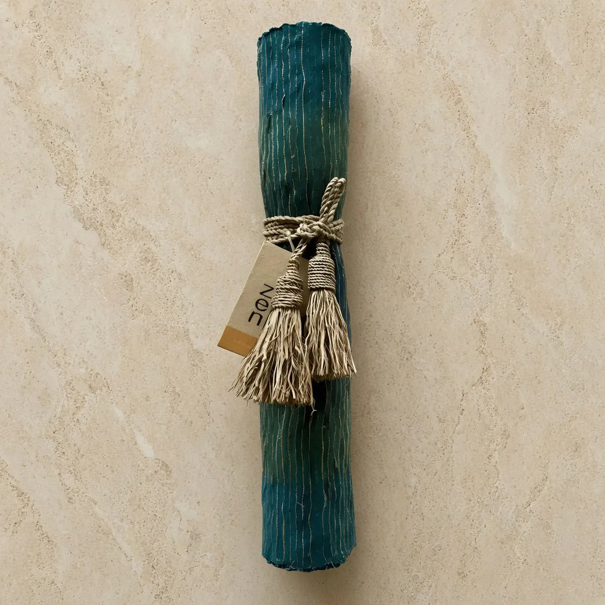 Teal striped handwoven vetiver table runner rolled and tied with natural rope in deep blue teal and green colors