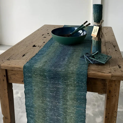 Handwoven vetiver table runner in deep blue teal and green with textured gradient and subtle woven pattern