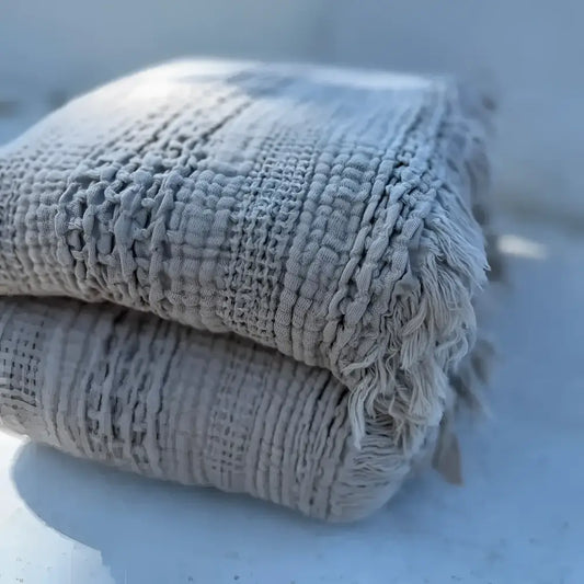 Textured gray blanket folded on light table