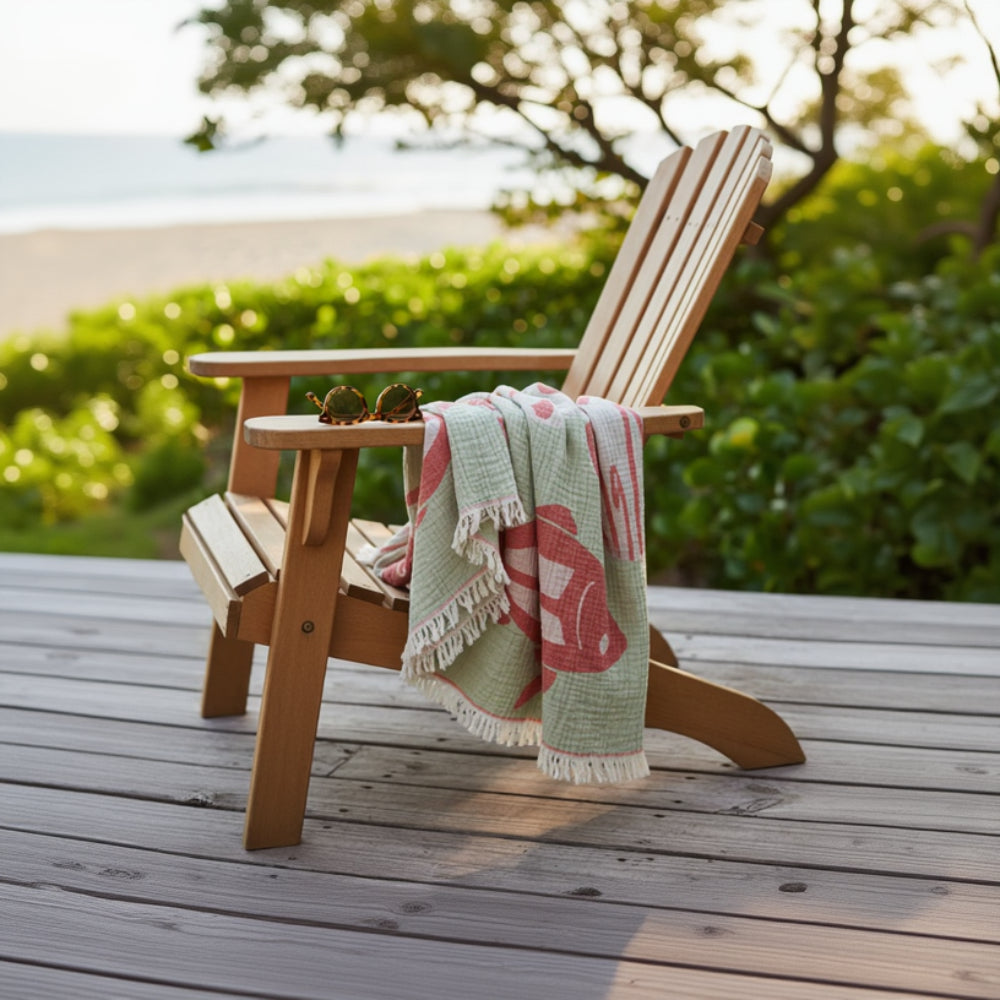 A turkish cotton harbor fish beach towel with pink and mint fish pattern white fringe edges sand repellent beach blanket