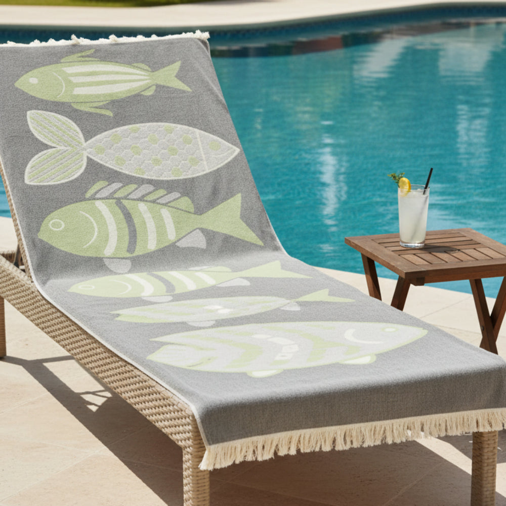Gray woven turkish cotton beach towel with four light green and white stylized fish perfect as a sand repellent beach blanket