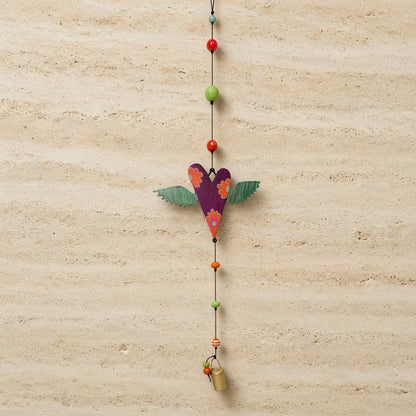 Purple wooden heart-shaped authentic nana bell wind chime with green wings orange floral patterns and brass bell on black cord