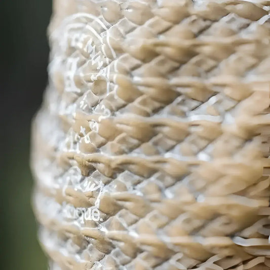 A vase shaped small planter with a woven bag shape and design