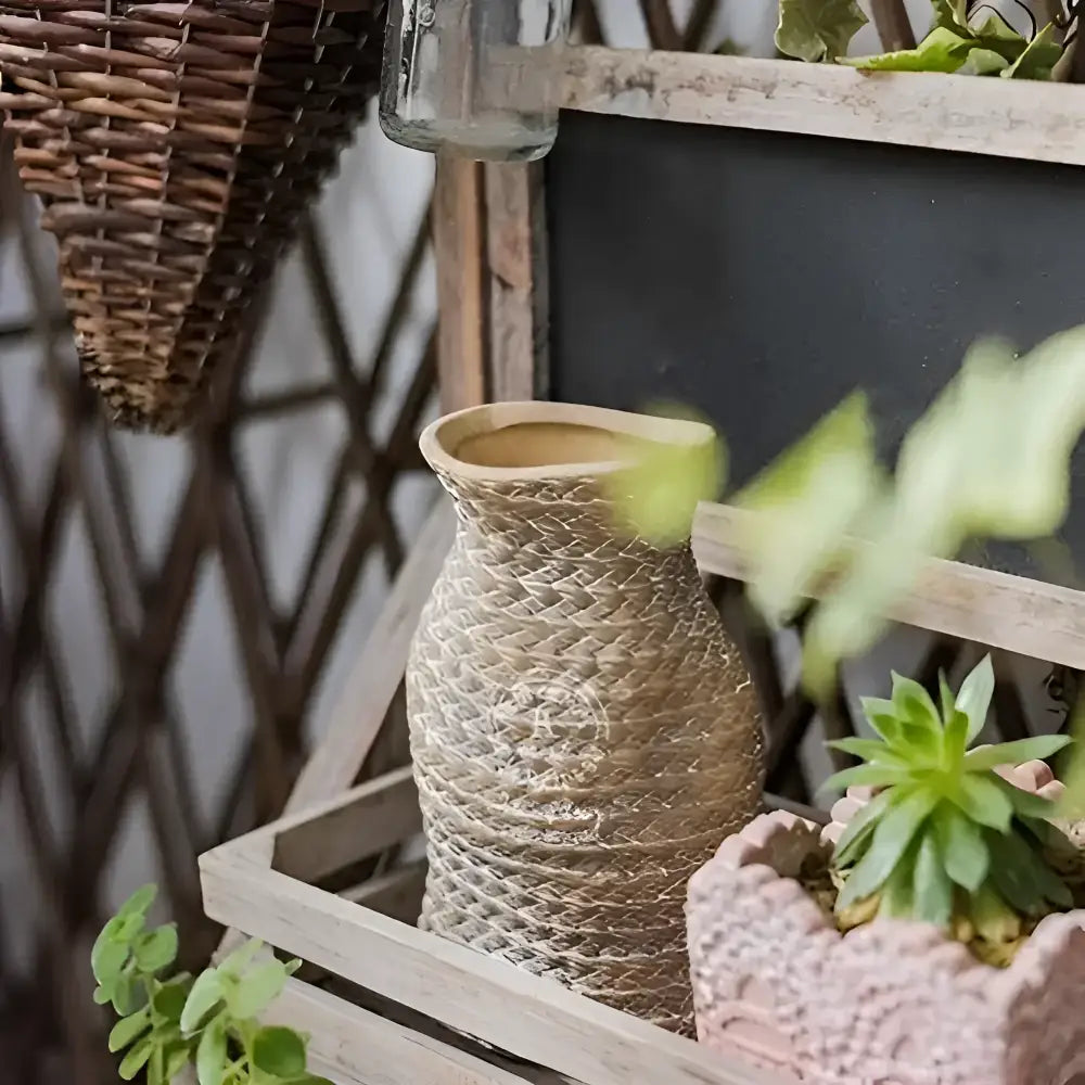 A vase shaped small planter with a woven bag shape and design