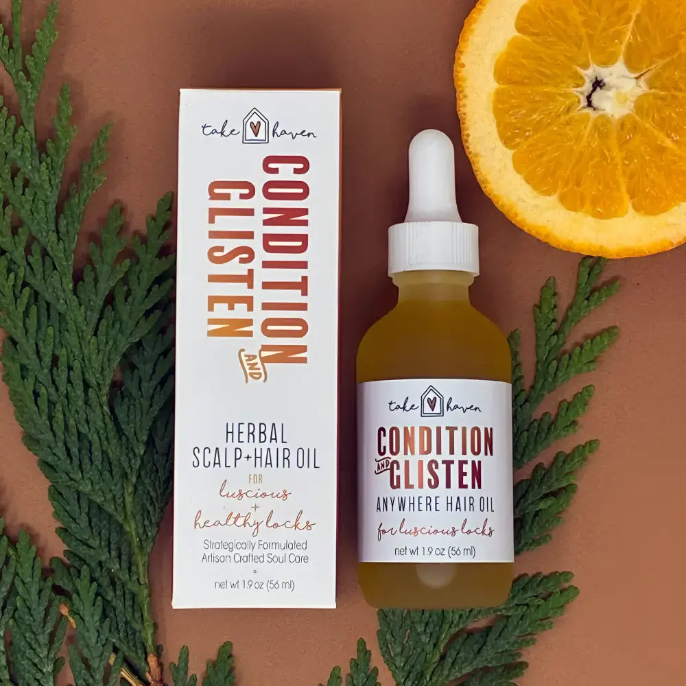 Take haven condition and glisten herbal hair oil in a clear glass bottle with white dropper cap and amber liquid