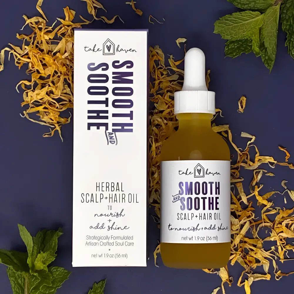 Take haven herbal hair oil smooth and soothe in clear glass bottle with white dropper cap containing golden essential oils