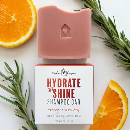 A pink herbal shampoo bar with nourishing organic oils shaped like a house with a heart provides dandruff relief