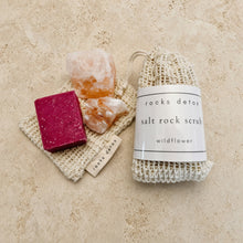 Beige knitted drawstring bag of pink himalayan salt scrub with wildflower scent and handmade organic shea label
