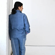 Person in Indigo Tribeca Loungewear Set made of premium Turkish cotton, long sleeve collared, barefoot