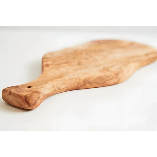 Olivewood cutting paddle board on a white surface