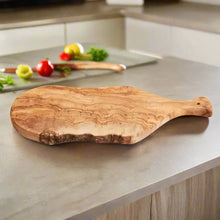 Natural-edged Italian Olivewood cutting board with handle and bark edge for kitchen prep