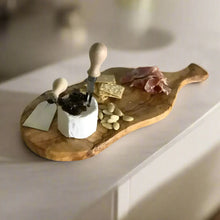 Italian olivewood cutting board with bark edge, cheese, crackers, nuts, and cured meat