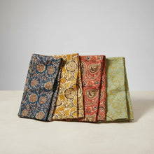 Four folded colorful block print tea towel with floral and paisley patterns for Kalamkari tea towel
