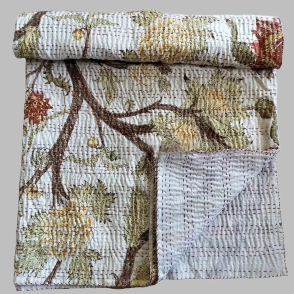 A traditional Indian kantha quilt with block printed tree design.