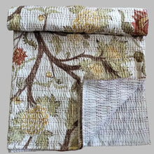 A traditional Indian kantha quilt with block printed tree design.