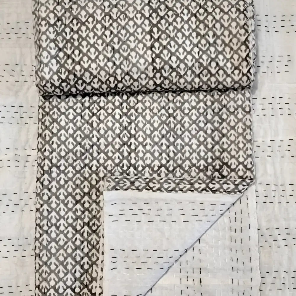 Traditional Indian Kantha quilt with block print in tan.