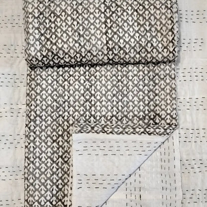 Traditional Indian Kantha quilt with block print in tan.