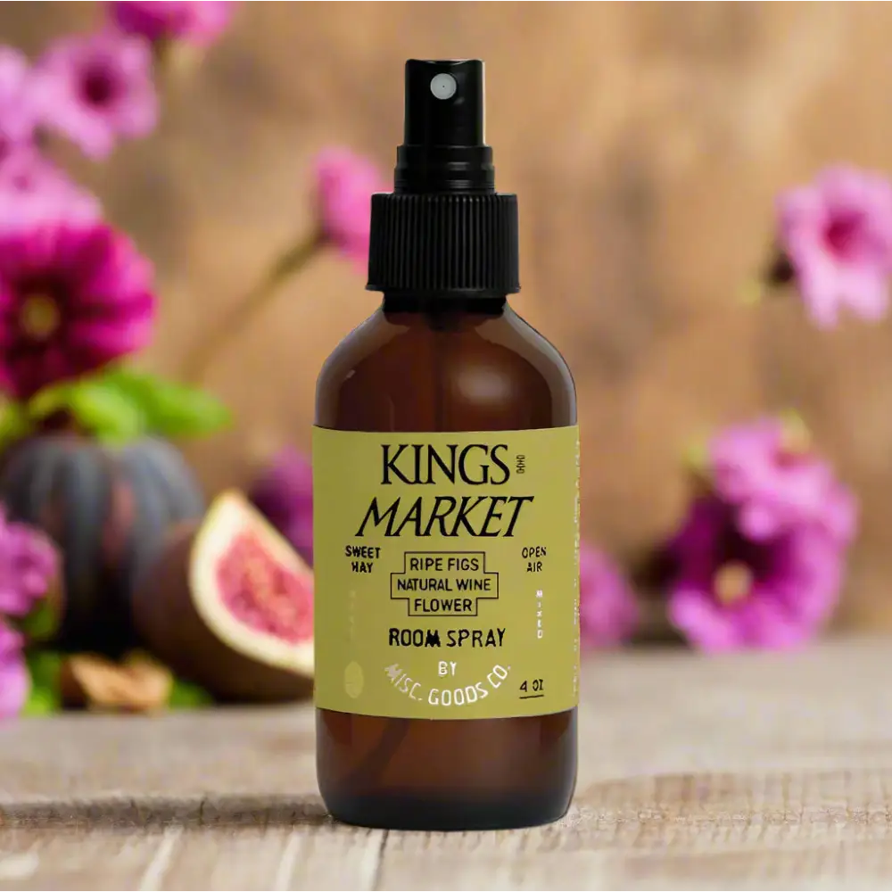 Kings Market Room Spray –bottle on wood surface with flowers in background