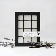 Lavender vanilla wax melts in a black grid box with white labels featuring warm vanilla beans and french lavender scent