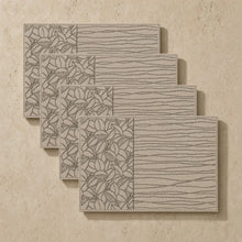 Set of four beige woven placemats with embroidered floral and wood grain patterns in a neutral design placemat style