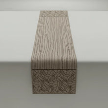 Beige woven table runner with abstract leaf and line patterns for a modern look