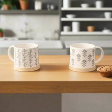Three white leafy green stoneware mugs with gray botanical patterns for a cozy vibe